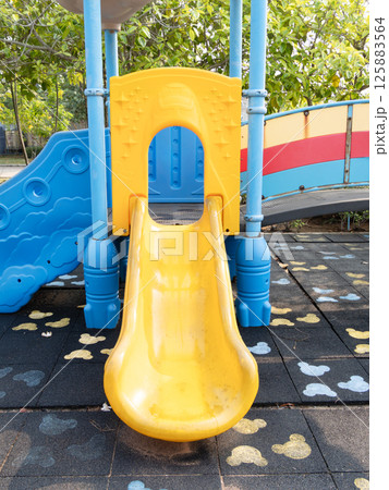 Children playing yellow slide at playground outdoor fun vibrant environment bird's eye view 125883564