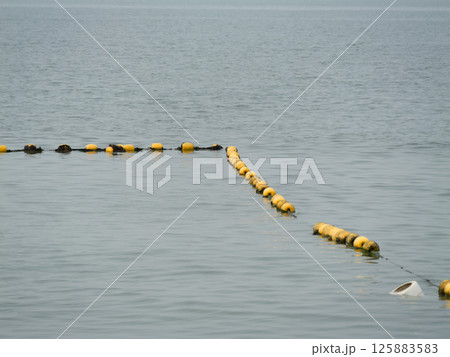 Floating buoys marking water boundaries coastal area calm waters aerial view marine safety Floating buoys marking water boundaries coastal area calm waters aerial view marine safety 125883583