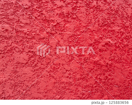 Textured red wall surface abstract art indoor close-up vibrant color concept 125883656