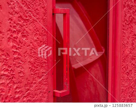 Red door handle urban setting close-up vibrant environment artistic perspective Red door handle urban setting close-up vibrant environment artistic perspective 125883657