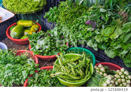 assortment of fresh vegetables and salad greens at Asian farmers market assortment of fresh vegetables and salad greens at Asian farmers market 125886419