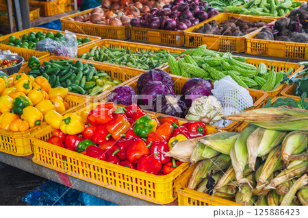 assortment of fresh vegetables on counter at street farmers market in Vietnam in Asia 125886423