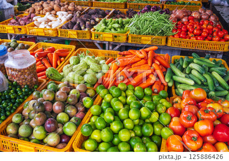 assortment of fresh vegetables on the counter at street grocery farmers market in Asia 125886426
