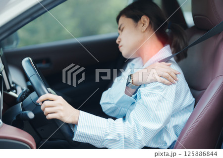 woman with her shoulder and neck sprain while driving car long time, muscle painful. Shoulder ache, Scapular pain, office syndrome and ergonomic concept 125886844
