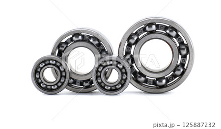 Four metallic ball bearings standing isolated on white background Four metallic ball bearings standing isolated on white background 125887232