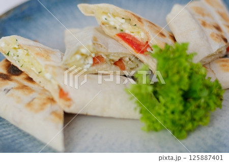 Mexican tortilla with meat stuffing, corn and vegetable salsa Mexican tortilla with meat stuffing, corn and vegetable salsa 125887401