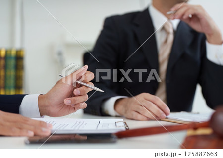 Client Consultation and Legal Advice. A lawyer providing valuable advice to a client during a professional meeting. Client Consultation and Legal Advice. A lawyer providing valuable advice to a client during a professional meeting. 125887663