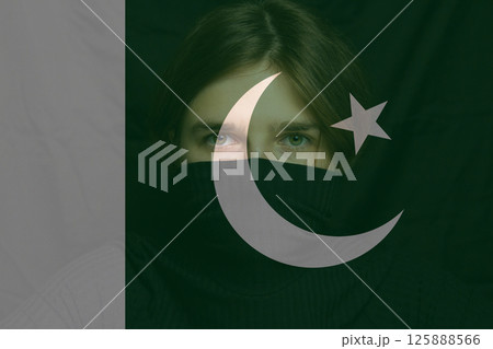 Woman, a refugee from war, holds a Pakistani flag. A victim of conflict, among many women seeking refuge. War between India and Pakistan Woman, a refugee from war, holds a Pakistani flag. A victim of conflict, among many women seeking refuge. War between India and Pakistan 125888566