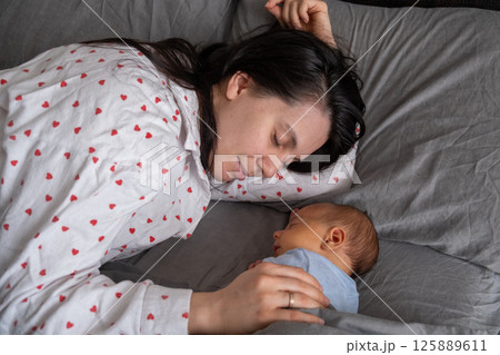 Mother and Baby Sleeping Peacefully Together 125889611