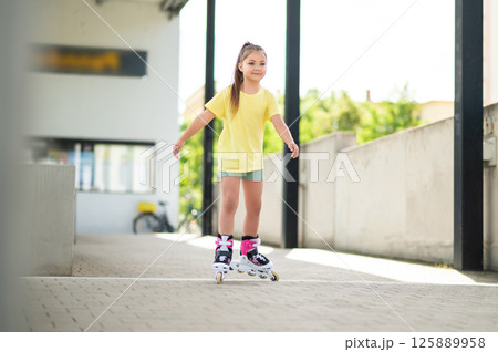 Active child riding roller-blades outside having fun Active child riding roller-blades outside having fun 125889958