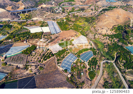 Top view of greenhouses in a mountainous area. Maro, Malaga, Spain. The Manantial Viaduct on the left top corner Top view of greenhouses in a mountainous area. Maro, Malaga, Spain. The Manantial Viaduct on the left top corner 125890483