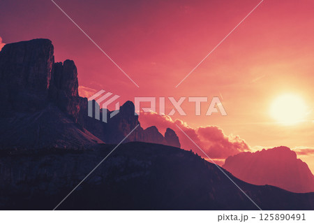 Silhouette of rocks against the sunset sky. Mountain landscape background. The dolomites in South Tyrol, Italy, Europe 125890491