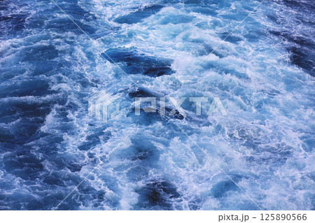 Natural water raging stream, trace of the boat propeller 125890566