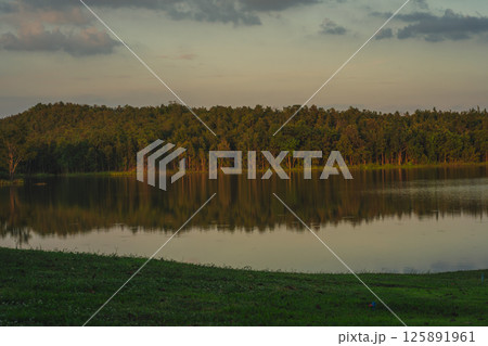 travel and people activity concept with twilight sky with reflection of mountain on lake before sunset travel and people activity concept with twilight sky with reflection of mountain on lake before sunset 125891961