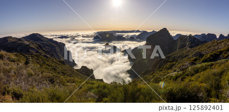 Epic Sunset View in High Mountain Landscape in Madeira Island . Clouds in the Valley . 125892401