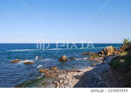 Beautiful landscape of the Black Sea. The natural coastline of the Odessa Bay consists of shell rock and clay against which the sea waves break. 125893424