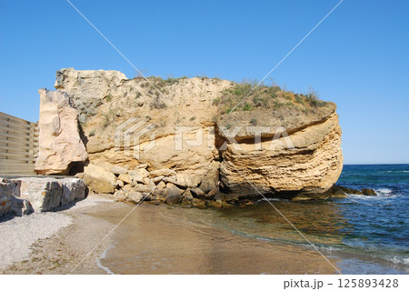 Beautiful landscape of the Black Sea. The natural coastline of the Odessa Bay consists of shell rock and clay against which the sea waves break. 125893428