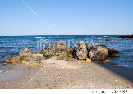 Beautiful landscape of the Black Sea. The natural coastline of the Odessa Bay consists of shell rock and clay against which the sea waves break. 125893429