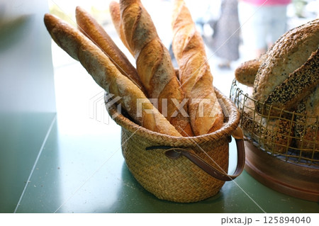 Fresh bread in a basket on a white background 125894040