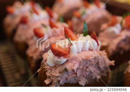 round croissant with strawberries Creme-filled circular croissants with different filling and glaze. Round French or New-York Roll croissants isolated on white background 125894046