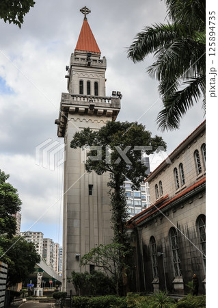 May 5 2025 Historic Church Building with Tree-Lined Grounds and Clear Sky 125894735
