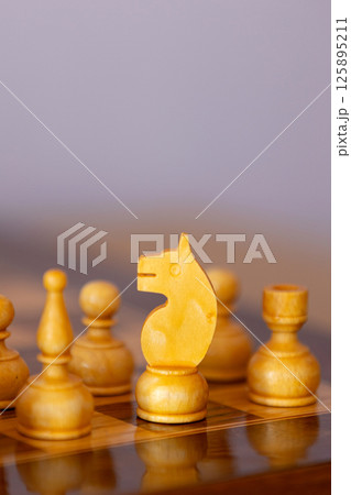 Wooden white chess pieces on the chessboard 125895211