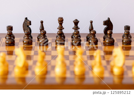 Wooden black chess pieces on the chessboard 125895212