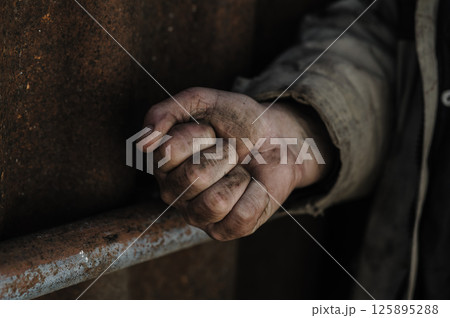 The hands of a poor man. A homeless man shows one fist. The hands of a poor man. A homeless man shows one fist. 125895288