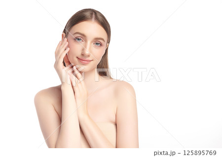 A beautiful young woman with clean, fresh skin against a white background. Skincare, facial treatment, cosmetology, beauty, and spa. An elegant portrait of an woman. A beautiful young woman with clean, fresh skin against a white background. Skincare, facial treatment, cosmetology, beauty, and spa. An elegant portrait of an woman. 125895769
