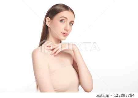 A beautiful young woman with clean, fresh skin against a white background. Skincare, facial treatment, cosmetology, beauty, and spa. An elegant portrait of an woman. A beautiful young woman with clean, fresh skin against a white background. Skincare, facial treatment, cosmetology, beauty, and spa. An elegant portrait of an woman. 125895784