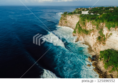 Cliff coastline with ocean and waves in Uluwatu, Bali. Drove view 125896552