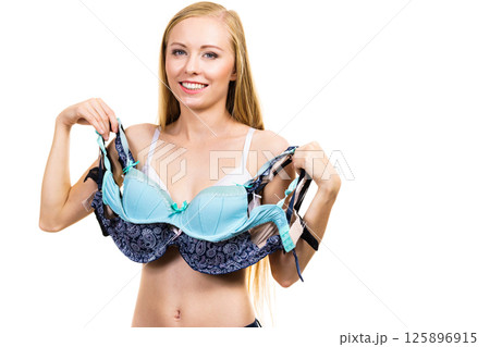 Woman holds bras, choosing 125896915