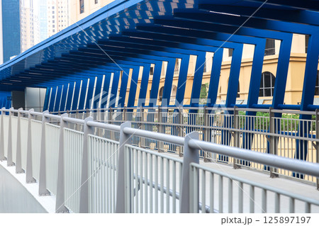 Modern futuristic overpass over the roadway in the city center 125897197