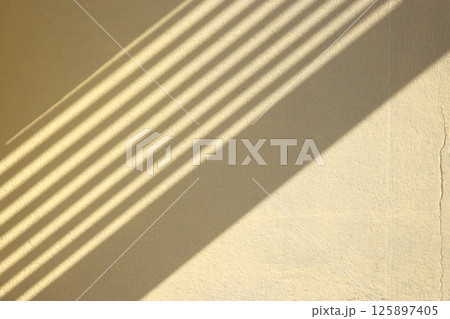 Soft light and shadows on simple textured walls. Soft light and shadows on simple textured walls. 125897405