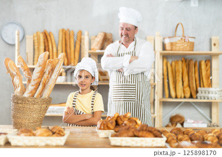 Father and little daughter - selling bread and various baguettes for sale 125898170
