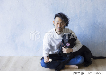 愛犬とくつろぐ男性 125898226