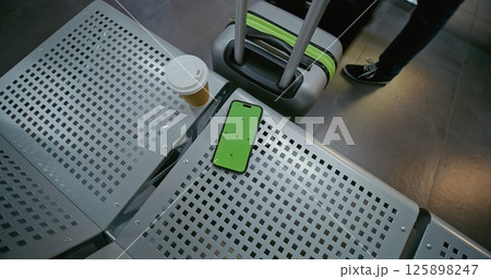 Airline Hub Lounge in Airport Terminal: Smartphone with Green Chroma Key Screen Mockup Lying on Seat Airline Hub Lounge in Airport Terminal: Smartphone with Green Chroma Key Screen Mockup Lying on Seat 125898247