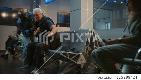 Airport Terminal: Senior Man Having Heart Attack. Diverse People Helping, Calling for Medical Help Airport Terminal: Senior Man Having Heart Attack. Diverse People Helping, Calling for Medical Help 125898421