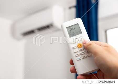 Adjust temperature on air conditioner 125898684