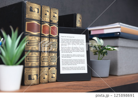 E-book reader device in home library 125898691
