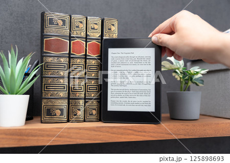 E-book reader device in home library E-book reader device in home library 125898693