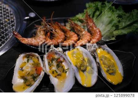 delicious Oysters shrimp Stir fried shrimp and squid on white dish delicious Oysters shrimp Stir fried shrimp and squid on white dish 125899078