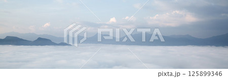 Mountain landscape. foggy morning. High angle view of trees in forest during foggy weather. Beautiful mountain and cloud natural landscape at sunrise in Thailand. panoramic banner with copy space. 125899346