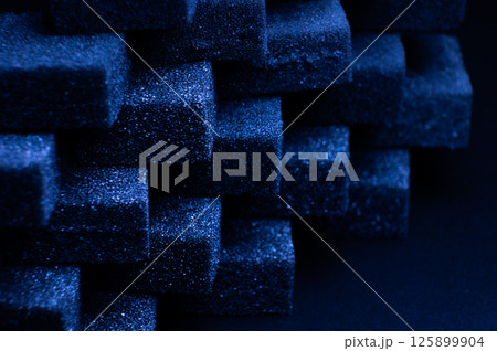 Blue Cubes of flexible foam sponges laid out in a pattern. Macro close-up in soft focus. Abstract cubic background Blue Cubes of flexible foam sponges laid out in a pattern. Macro close-up in soft focus. Abstract cubic background 125899904