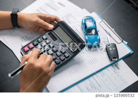Finance bank tax expense accounting budget money businessman hand for Business expense analysis saving use car Financial calculate accountant close up calculator with graph chart write office desk 125900532
