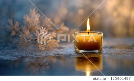 Candlelight on Icy Surface with Winter Decorations and Glow 125901497