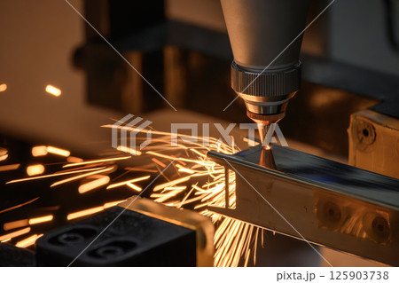 Close up scene the fiber laser cutting machine cut the square shape stainless steel tube with sparkling light. Close up scene the fiber laser cutting machine cut the square shape stainless steel tube with sparkling light. 125903738
