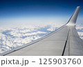 Airplane View of Snowy Mountains 125903760