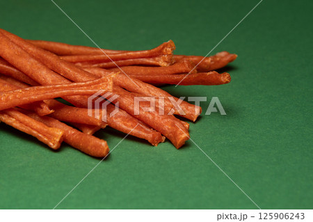 Sausages for beer on a green background. Snack food. Sausages for beer on a green background. Snack food. 125906243