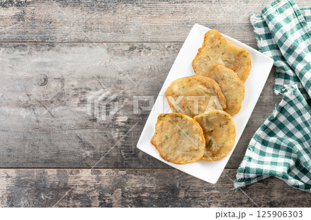 Tortillitas de camarones on wooden table. Traditional spanish food. Top view. Copy space 125906303